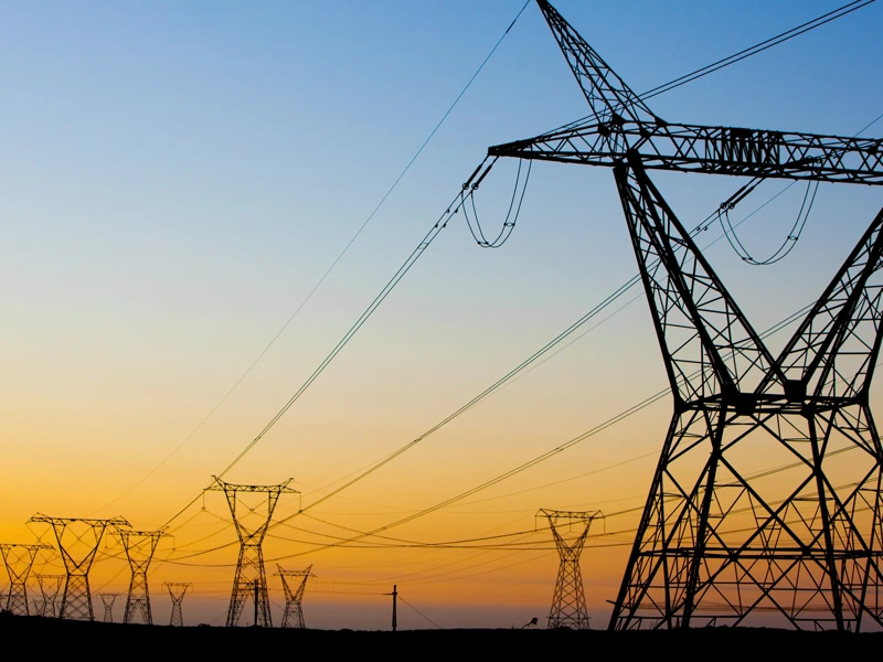 Stand under power lines in South Africa at sunset.