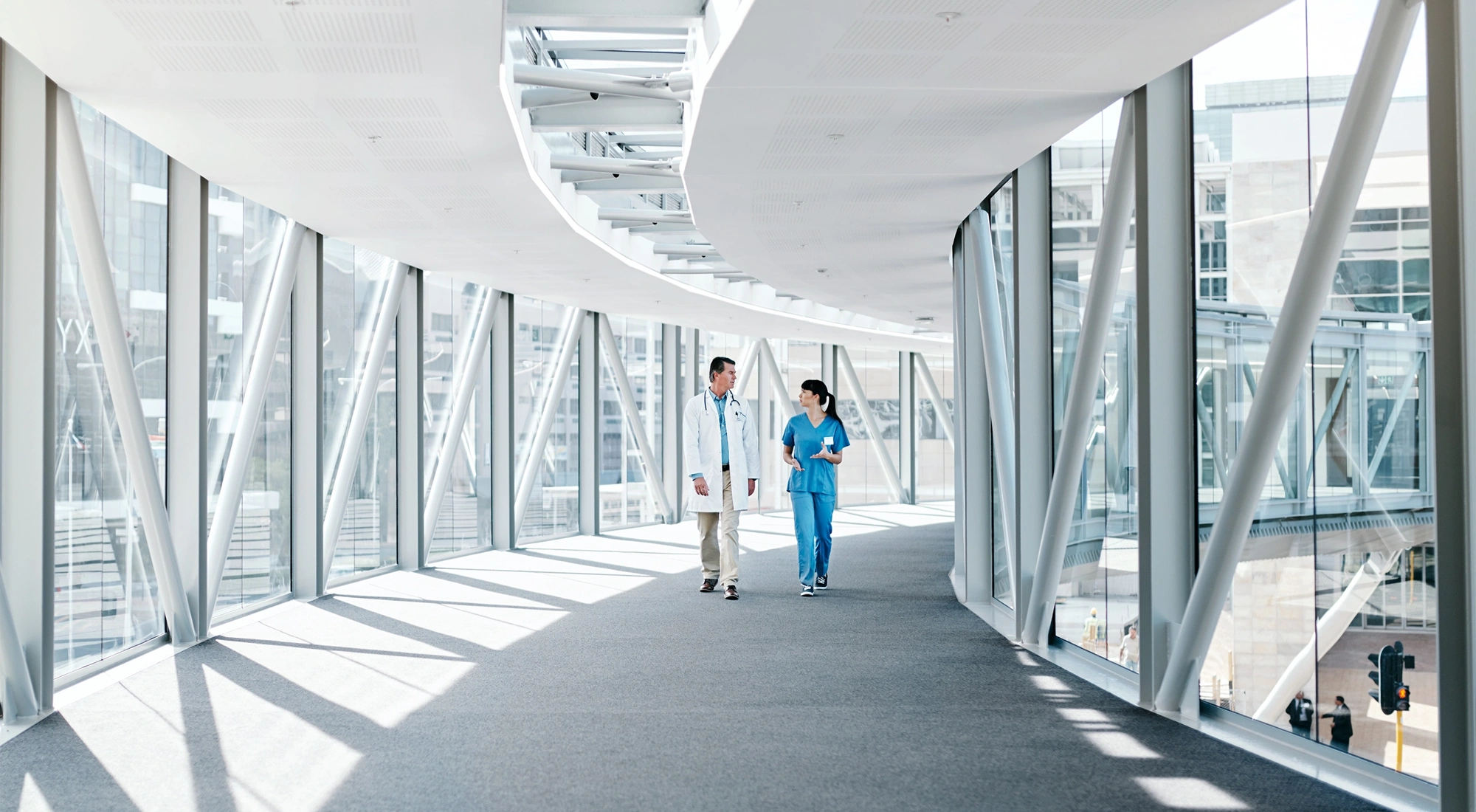 Two doctors walking down hallway.