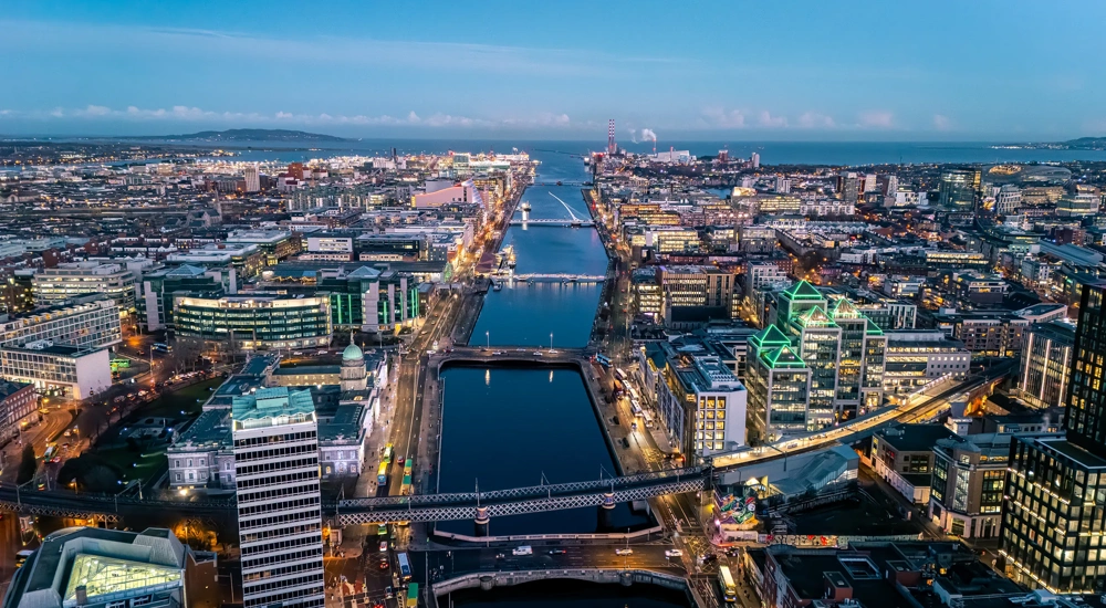 Aerial view of busy city center buildings and traffic at night, Aerial view of the river Liffey and city center Dublin Ireland at night.