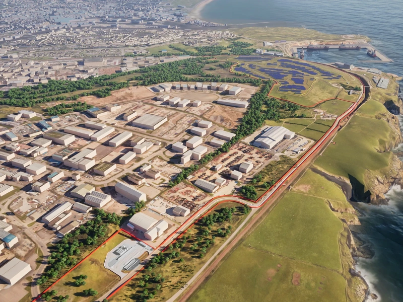 Ariel view of port with white block buildings in green field. There is also water surrounded.