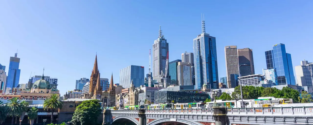 View of the city in Australia with the sky reflecting onto the buildings with a bridge showing