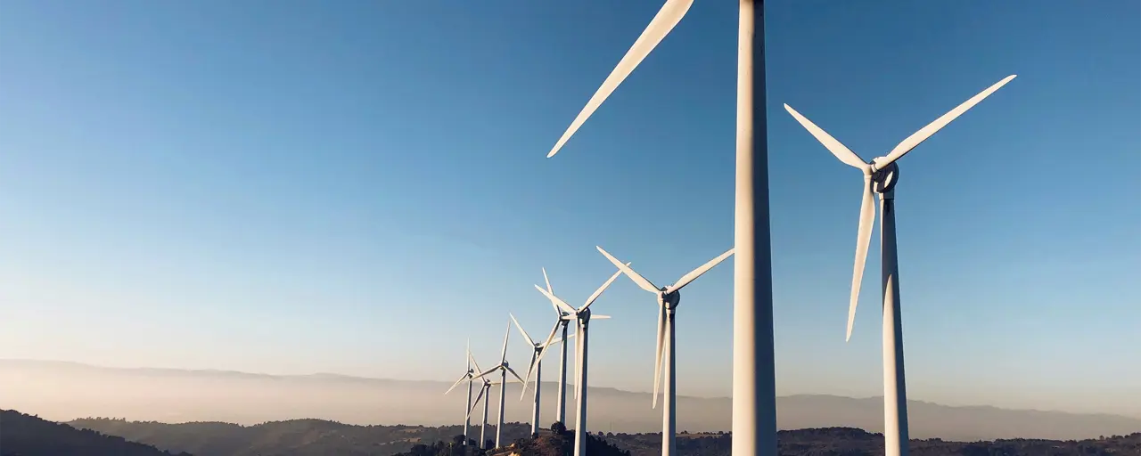 Sun setting with the windmills turning in a remote location