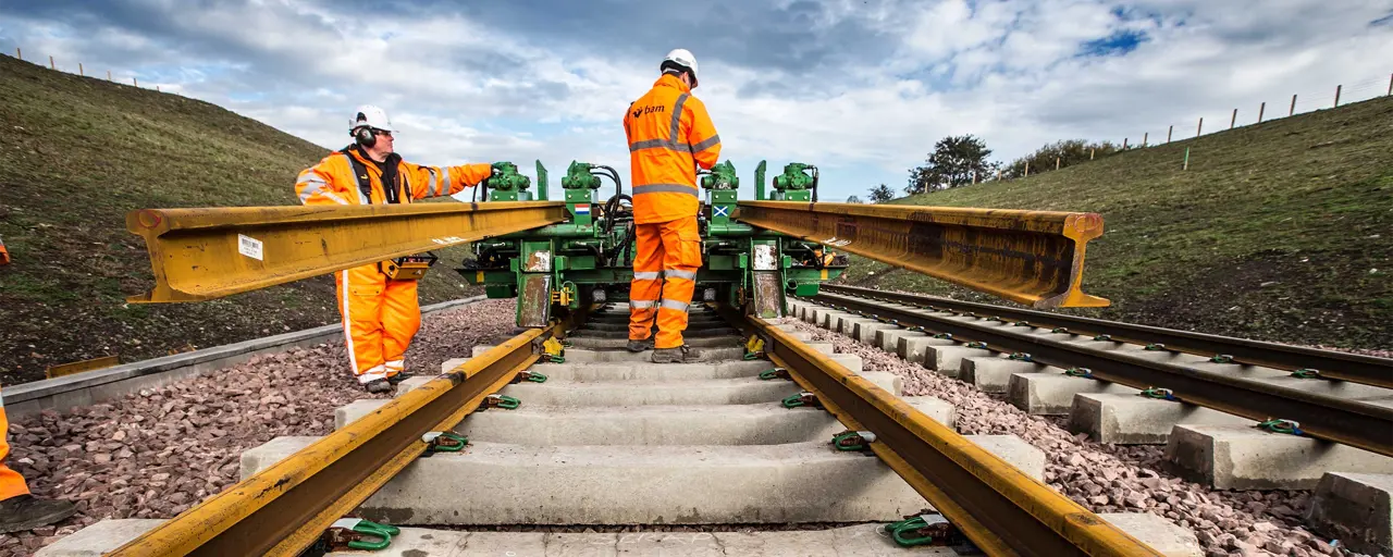 Railway workers laying track