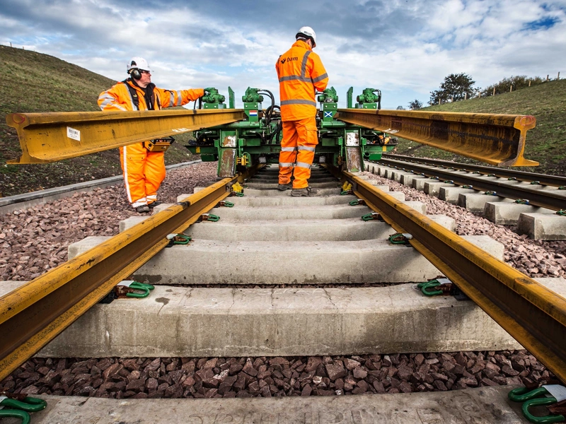 Railway workers laying track
