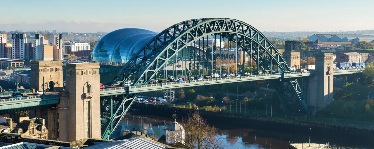 View of the bridge in a city with the sun out