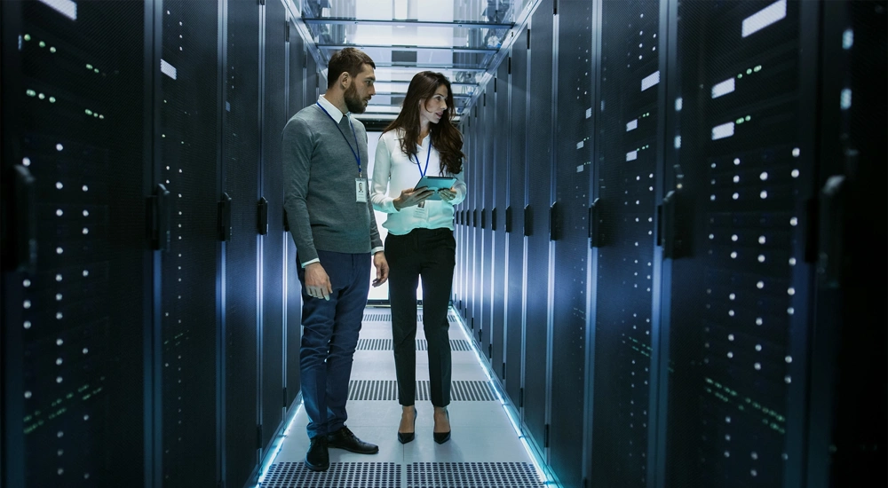 Man and women in data centre office