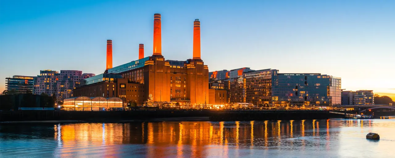 Skyline of Battersea Power Station with lake reflection