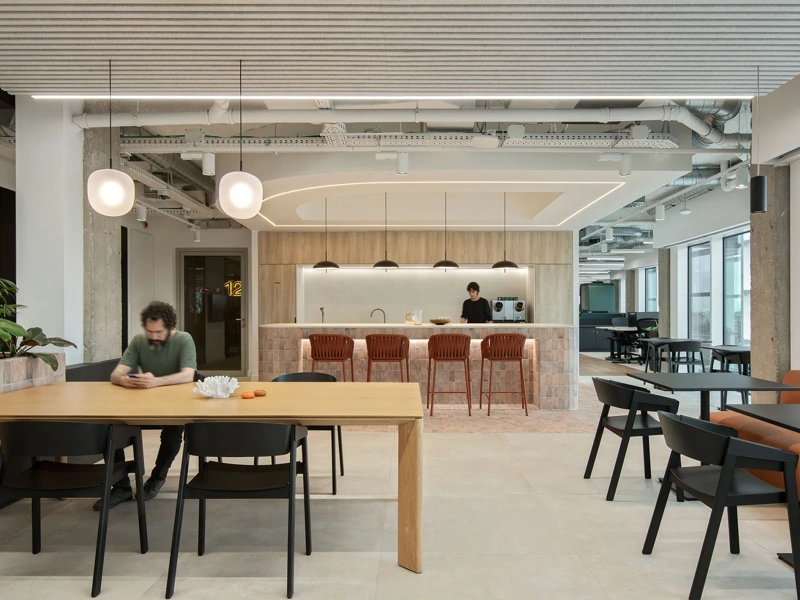 Modern office breakout area with tables, seating and a cafe style counter