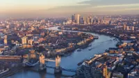 Aerial view of London at sunset with buildings surrounding the Thames