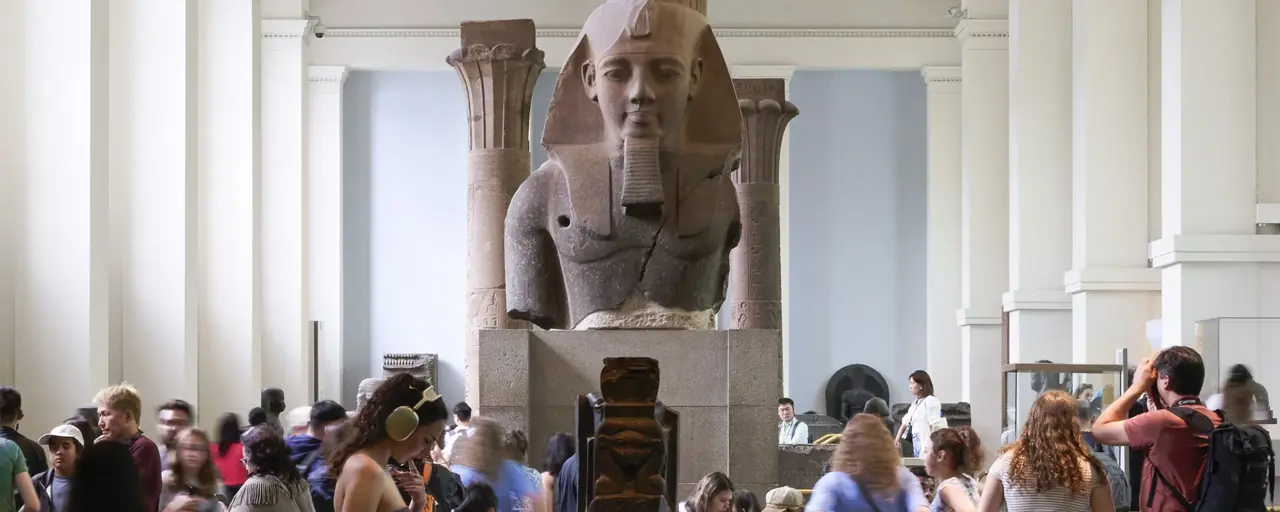 Egyptian Sculpture Gallery at the British Museum with a croud of people around it