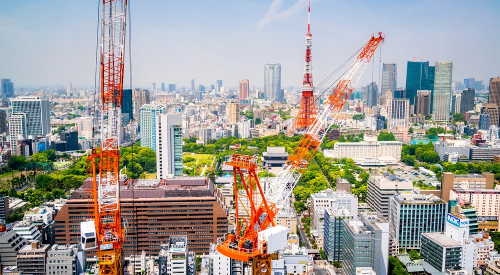 Aerial view of cranes in a construction site in downtown Tokyo.