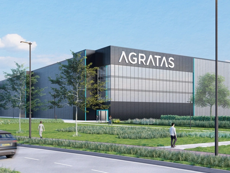 Render image of a battery plant with surrounding landscaping
