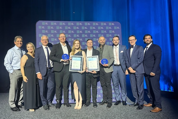 Group shot of award winners with awards