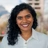 Portrait of Sonia Gomez, Associate Director, Marketing and Communications, Asia, Standing outside featuring an urban cityscape with tall buildings and a mix of architectural styles. The scene includes some trees with autumn foliage, adding a touch of color.