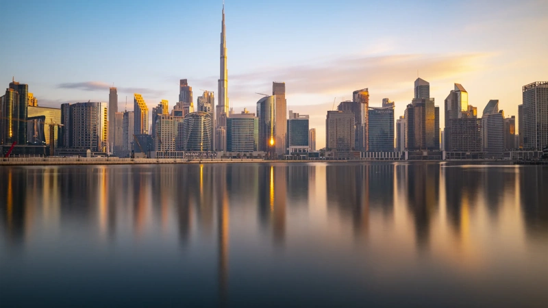 Long Exposure of The Business Bay Dubai City Skyline at Twilight, United Arab Emirates. Smooth Clouds and Water Due to Long Exposure with Reflections in the Still River