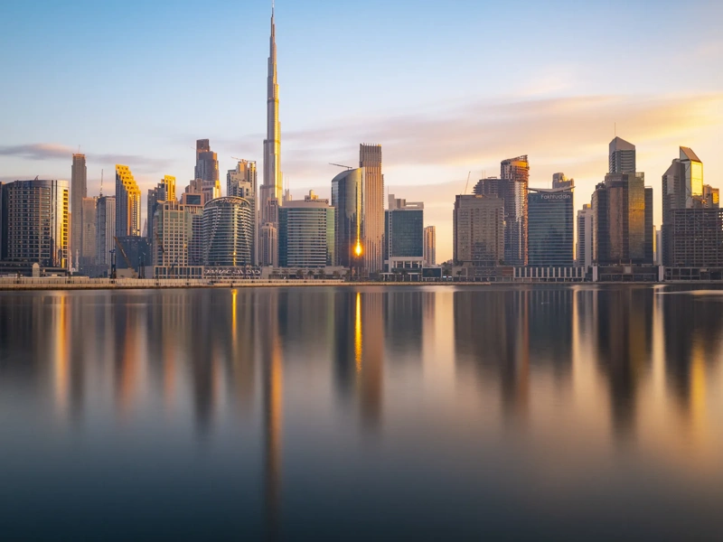 Long Exposure of The Business Bay Dubai City Skyline at Twilight, United Arab Emirates. Smooth Clouds and Water Due to Long Exposure with Reflections in the Still River