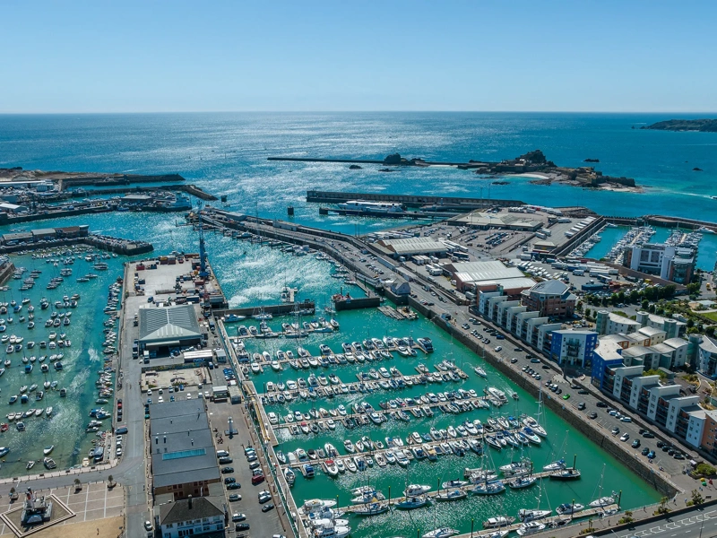 Jersey Harbours aerial with clear blue water and sky in the distance