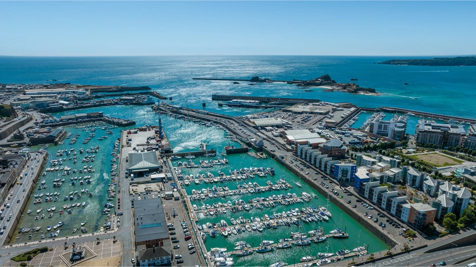 Jersey Harbours aerial with clear blue water and sky in the distance