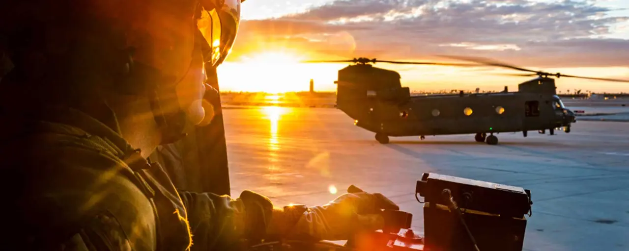 Soldier in army plane at sunset
