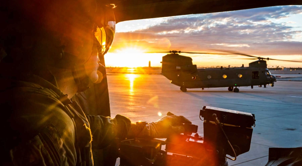 Soldier in army plane at sunset