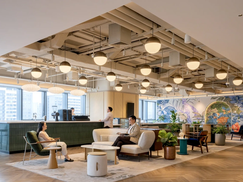 Coworkers conversing in Sanofi's open-plan office lounge, Chengdu, China