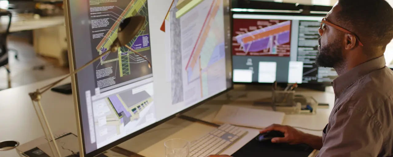 Man working at desk on laptop