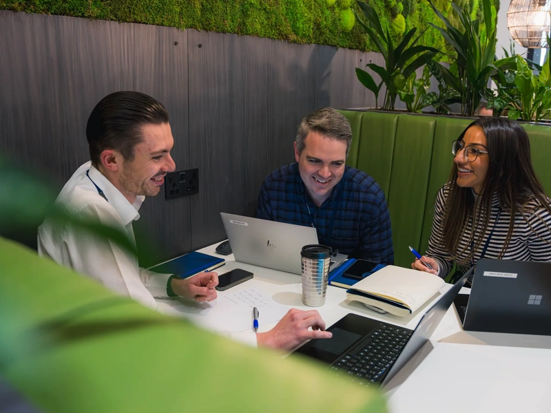 Coworkers converse in refurbished British Airways workspace