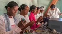 A group of six women working on solar technology
