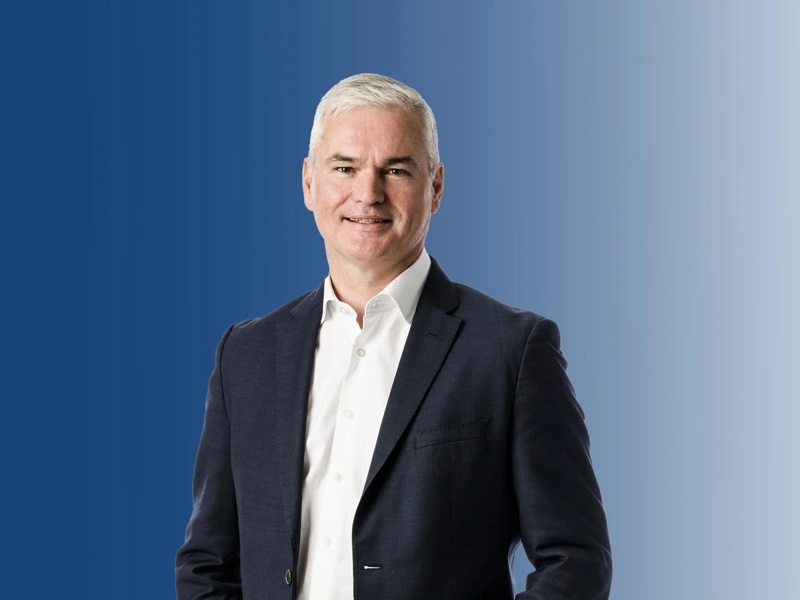 View of CEO Vincent standing and smiling