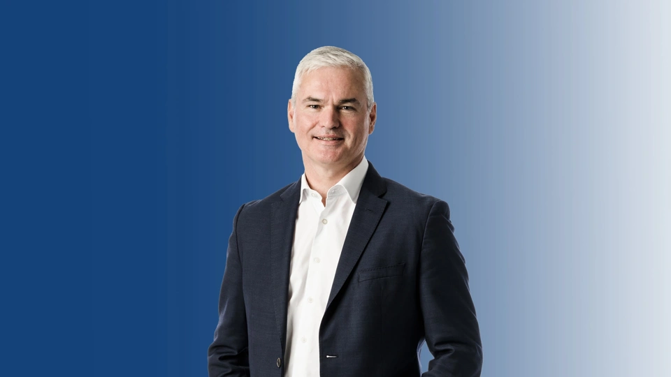 View of CEO Vincent standing and smiling