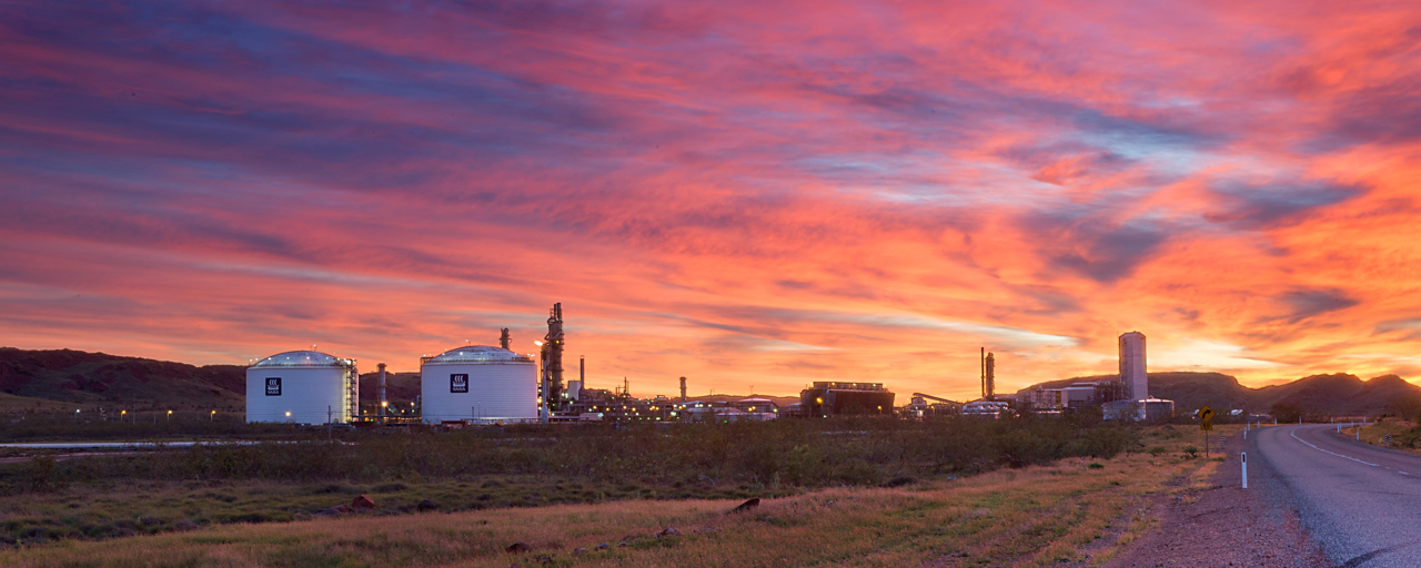 Picture of two tanks against pink, blue and orange sunset