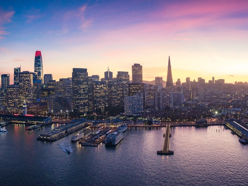 Skyline of marina with boats and city skyscrapers with lights