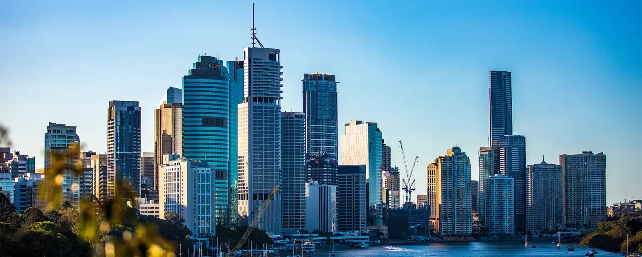 Skyscraper buildings beside boats on the water