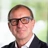 Steve Watts, Director, Real Estate, UK, in front of a window with trees behind him