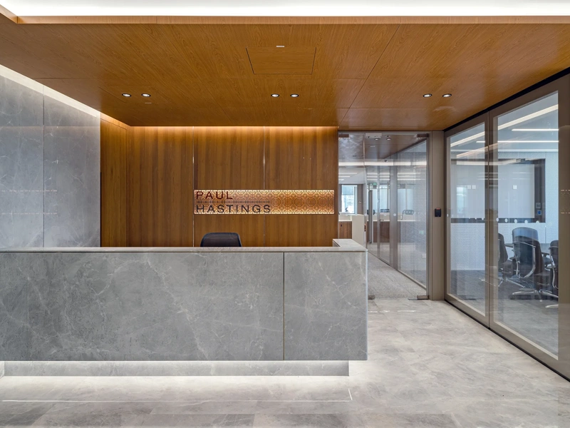 Grey stone and wooden panelled Paul Hastings reception interior, China