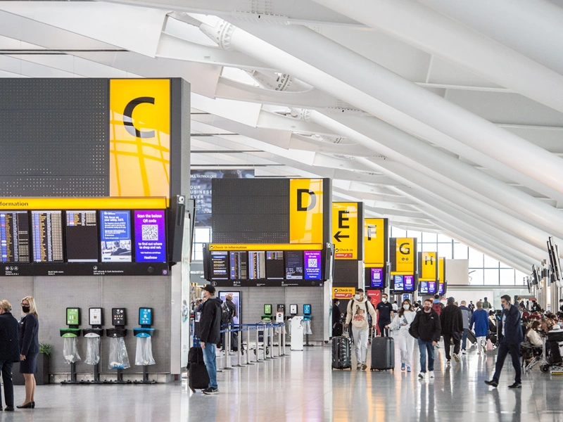 Check-in area and commuters at Heathrow Airport, UK.