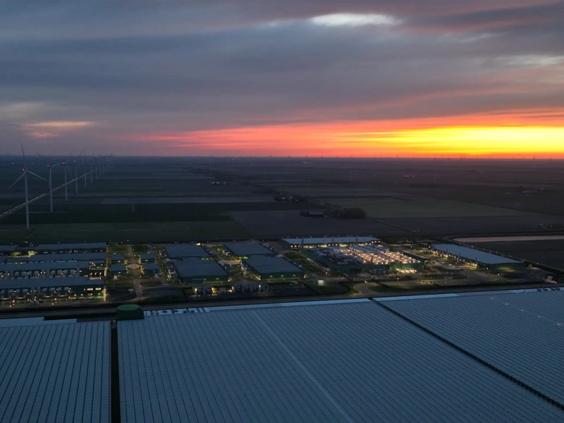 Large scale data center building complex in Middenmeer, The Netherlands, at night. Aerial view.