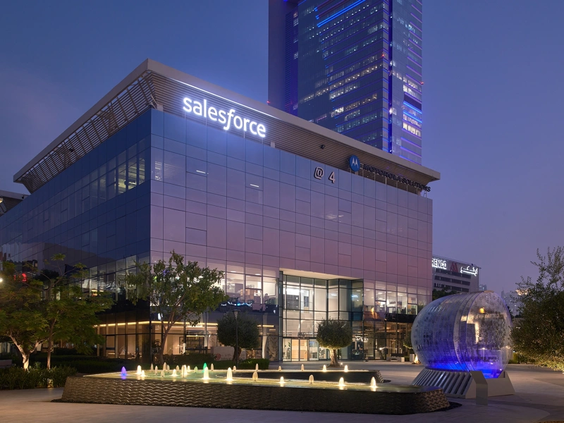 Exterior of Salesforce office at night with courtyard fountain in foreground, Dubai, UAE
