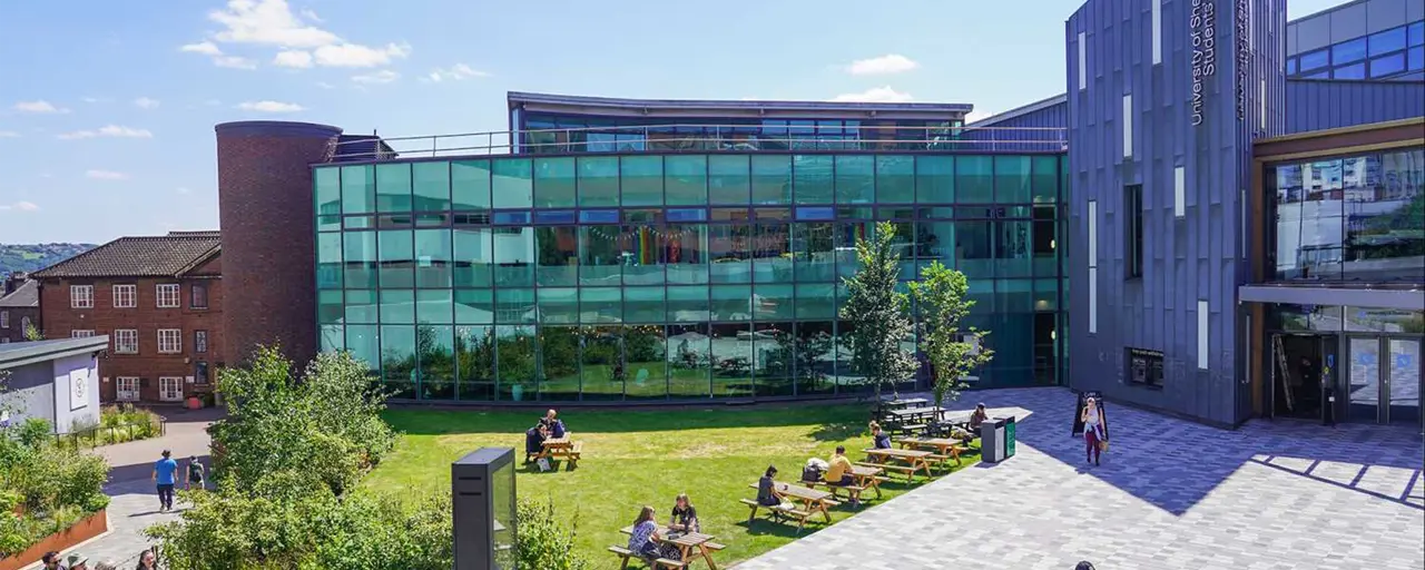 University of Sheffield’s student union, a modern building with students roaming the courtyard in front