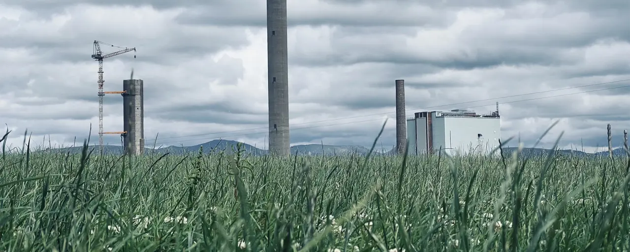 Factory in a landscape with green grass