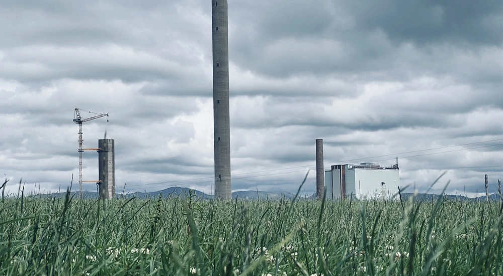 Factory in a landscape with green grass