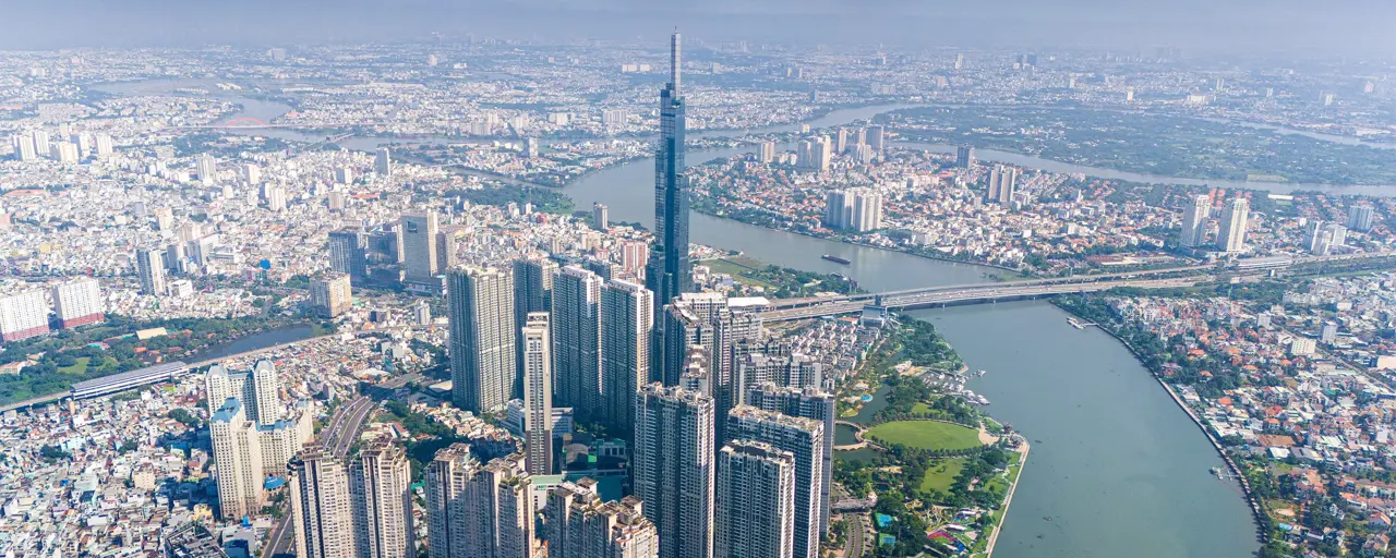 Aerial view of early morning at Landmark 81 is a super tall skyscraper in center Ho Chi Minh City, Vietnam and Saigon bridge with development buildings, energy power infrastructure