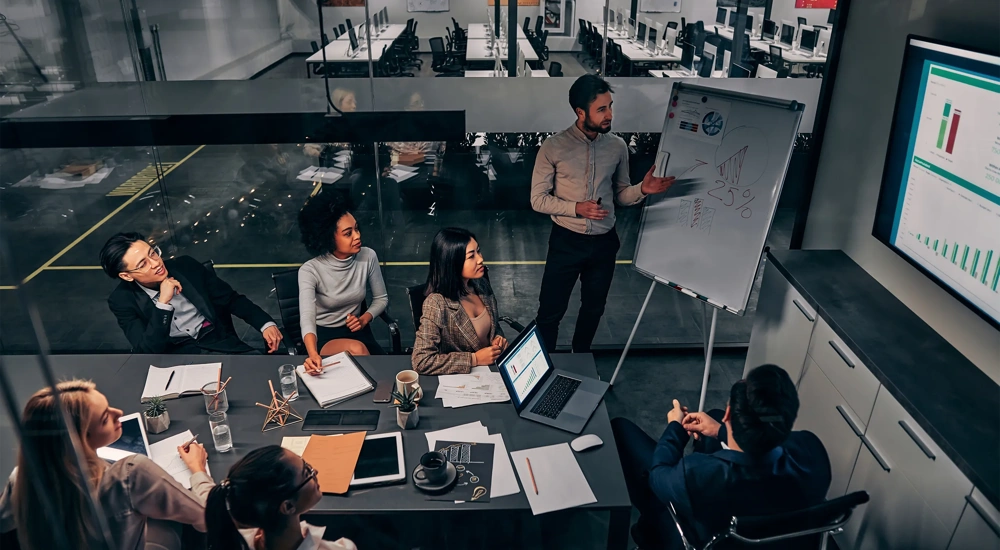 Business presentation. A group of handsome business people working in a spacious conference room in a large business center. Concept of startup, projects, planning, results, strategy.