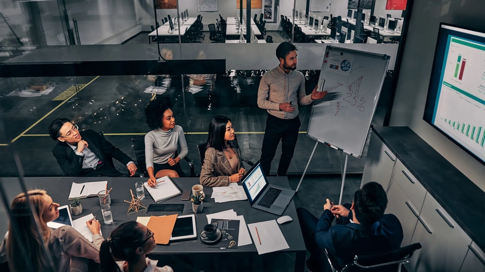 Business presentation. A group of handsome business people working in a spacious conference room in a large business center. Concept of startup, projects, planning, results, strategy.