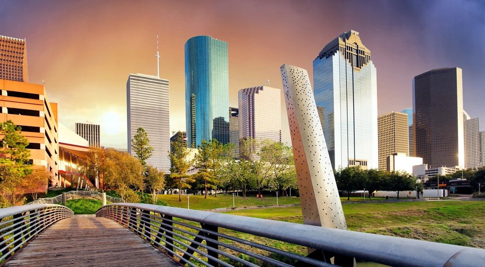 Collection of skyscrapers over a bridge at sunset