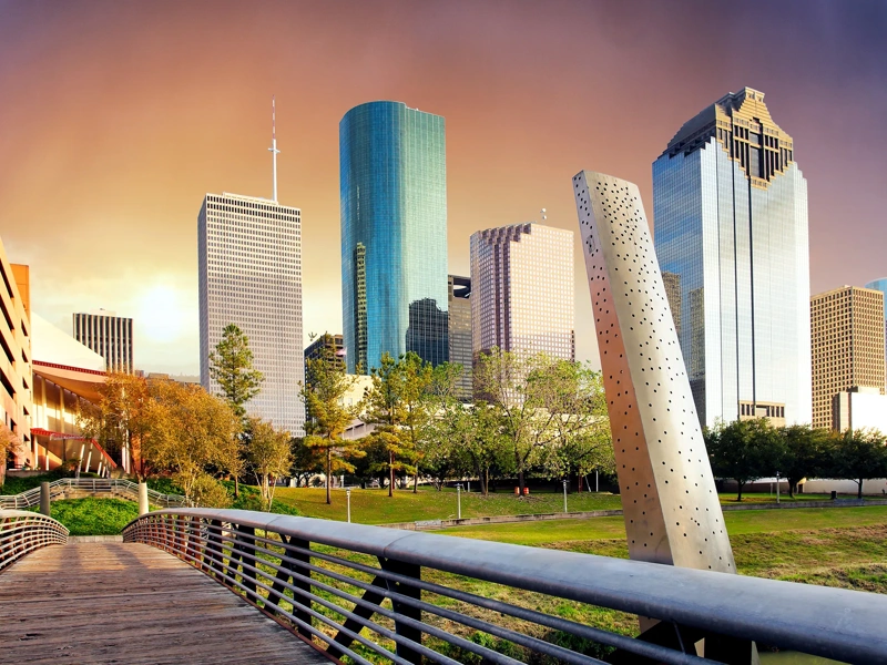 Collection of skyscrapers over a bridge at sunset