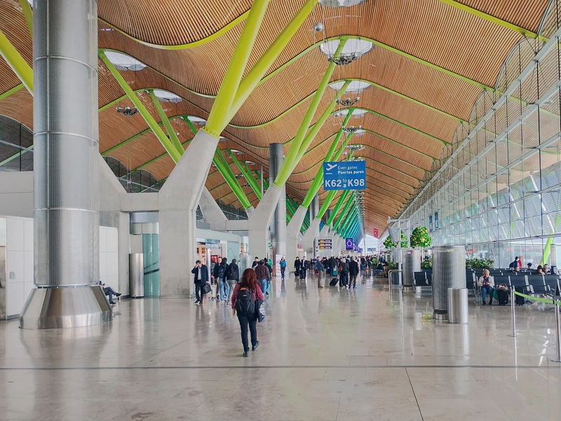 Interior of Terminal 4 at Madrid-Barajas airport beneath undulating, wooden-panelled ceiling, Spain