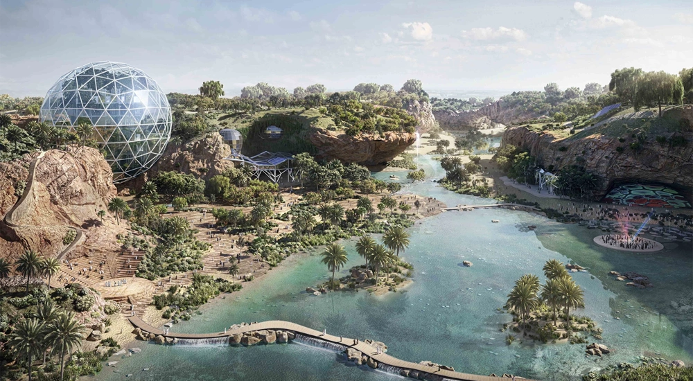An image of King Salman Park with a blue river running through the middle of a green area and a futuristic, silver dome on the left bank.