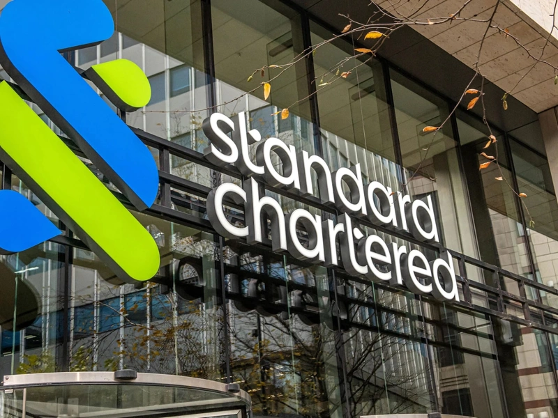 Standard Chartered glass office front with logo, London, UK