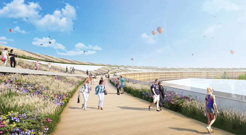Rendered image of promenade with people walking and exercising and hot air balloons in the distance